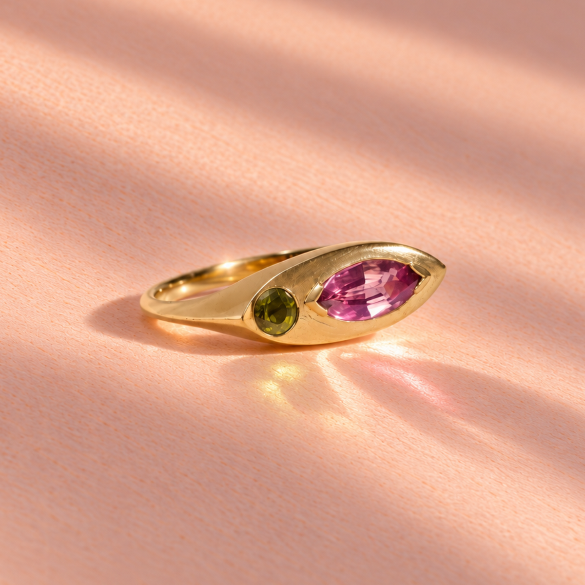 18k yellow gold ring featuring a marquise pink sapphire alongside green peridot in brilliant cut, crafted by Ruinette Bijoux as part of the Kitty Cat collection.