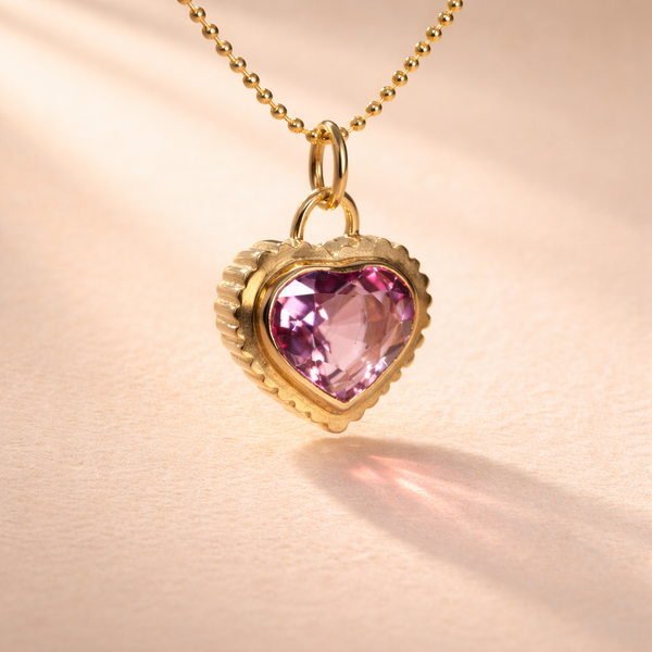 18k yellow gold Pink Garnet Heart Cut charm from Ruinette Bijoux radiates elegance with its captivating handcrafted design, ideal as a unique gift.