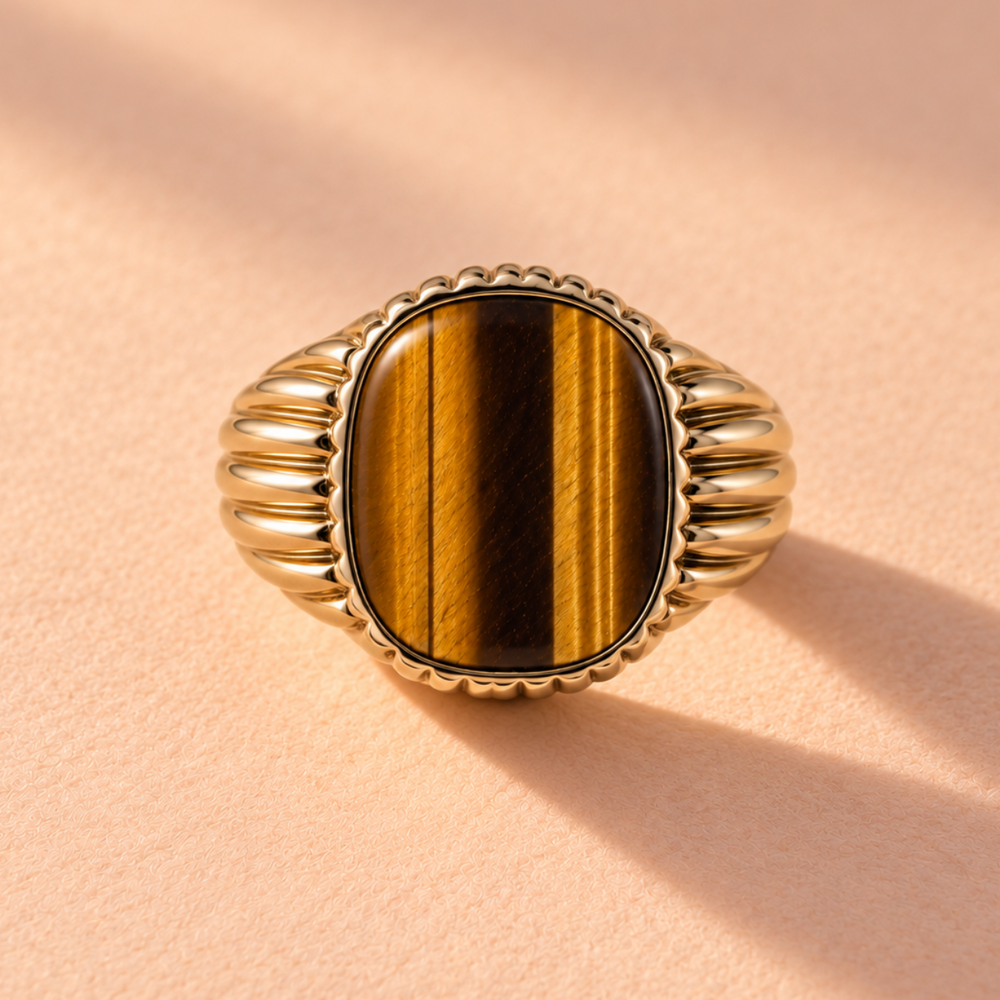 The Baby Rib Tiger's Eye Signet Mens Ring features a front view of its 18k yellow gold craftsmanship, showcasing its striking tigers eye stone. An artisan piece by Ruinette Bijoux, perfect as a one-of-a-kind statement ring.
