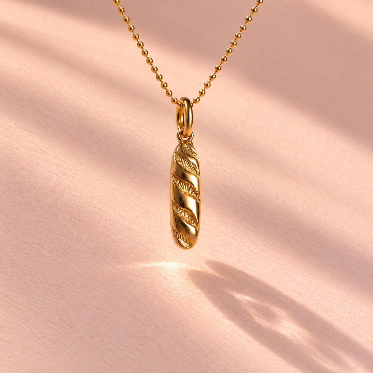 The Baguette Charm is showcased from the front, highlighting the 18k yellow gold craftsmanship, part of the Girl Dinner collection by Ruinette Bijoux.