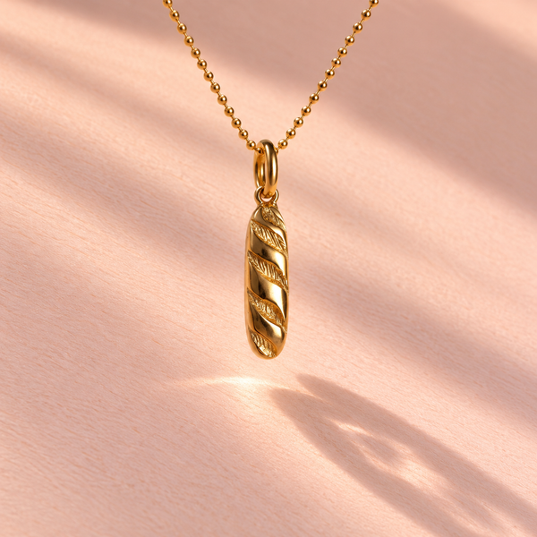 The Baguette Charm is showcased from the front, highlighting the 18k yellow gold craftsmanship, part of the Girl Dinner collection by Ruinette Bijoux.