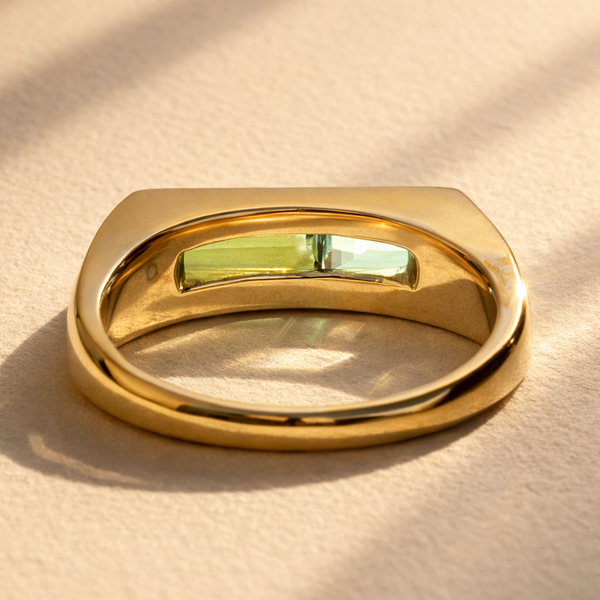 Duet Ring no. 01 crafted in 18k yellow gold showcasing a back view with blue topaz and green tourmaline baguettes.