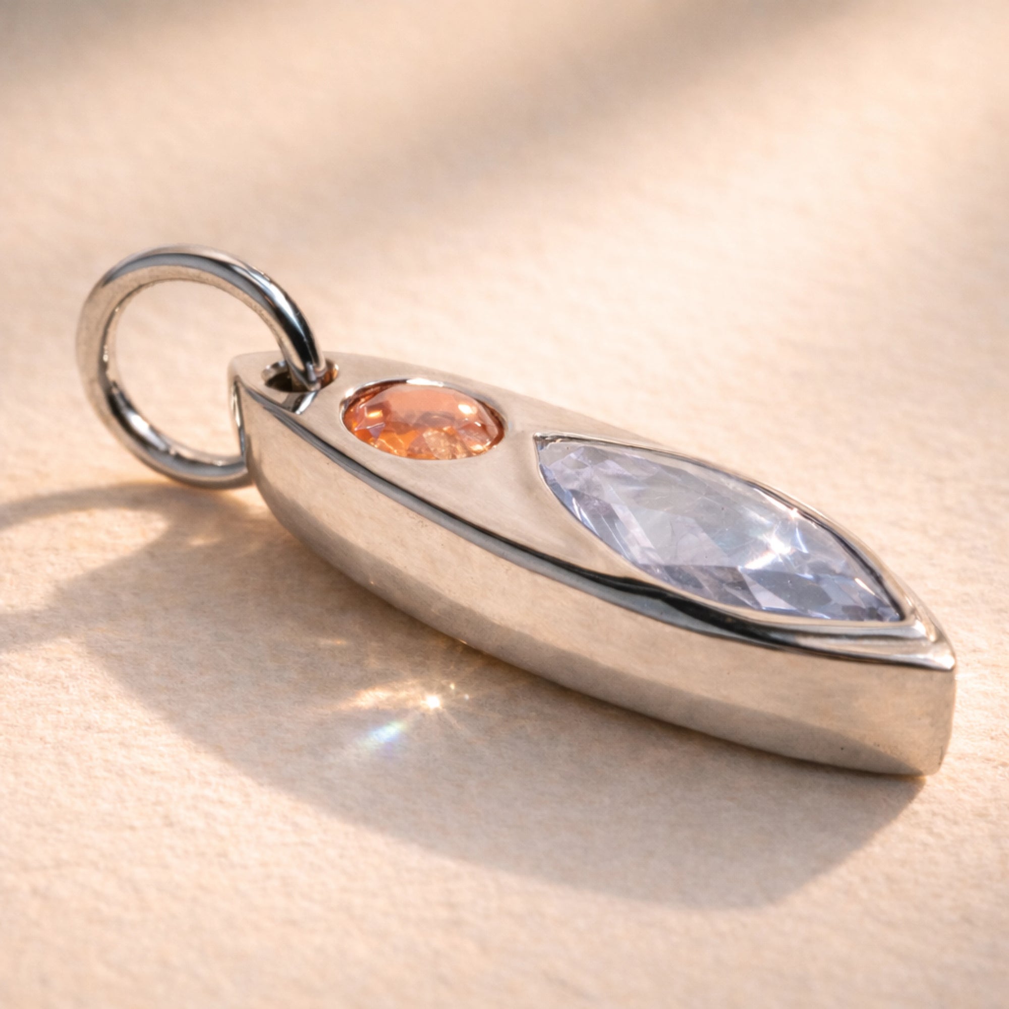 Ruinette Kitty Cat Charm No. 1  in 18k white gold featuring round peach imperial topaz and marquise-cut lavender spinel navette pendant on ball chain, side view