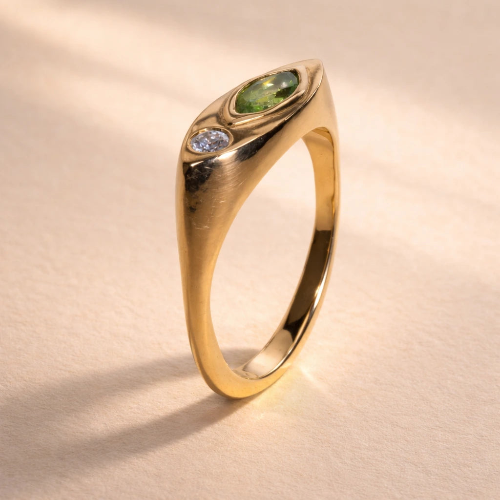 Ruinette Kitty Cat Ring I profile view showing dimensional 18k yellow gold design with bezel-set marquise peridot and round brilliant diamond