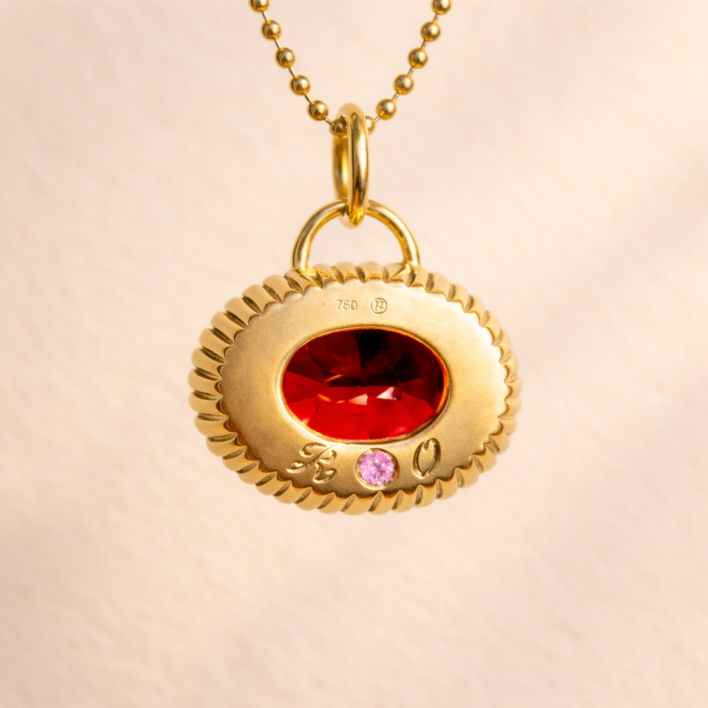Custom Olivia's Baby Rib Garnet Charm pendant back view in 18k yellow gold features an oval brilliant cut garnet. Handcrafted in the French Alps by Ruinette.