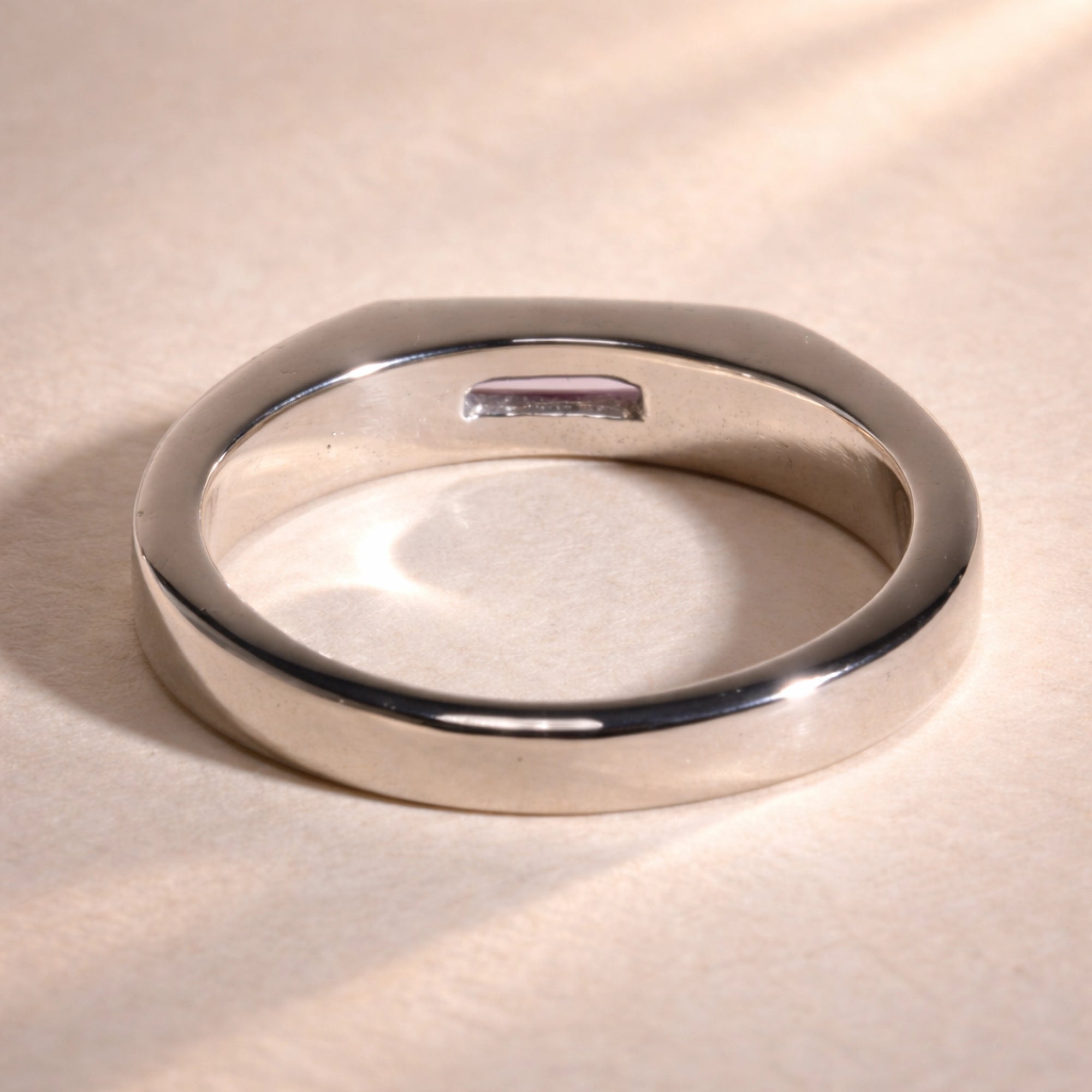 Ruinette Sapphire Stacking Signet Ring back view displaying smooth 18k white gold interior with pink sapphire visible through setting